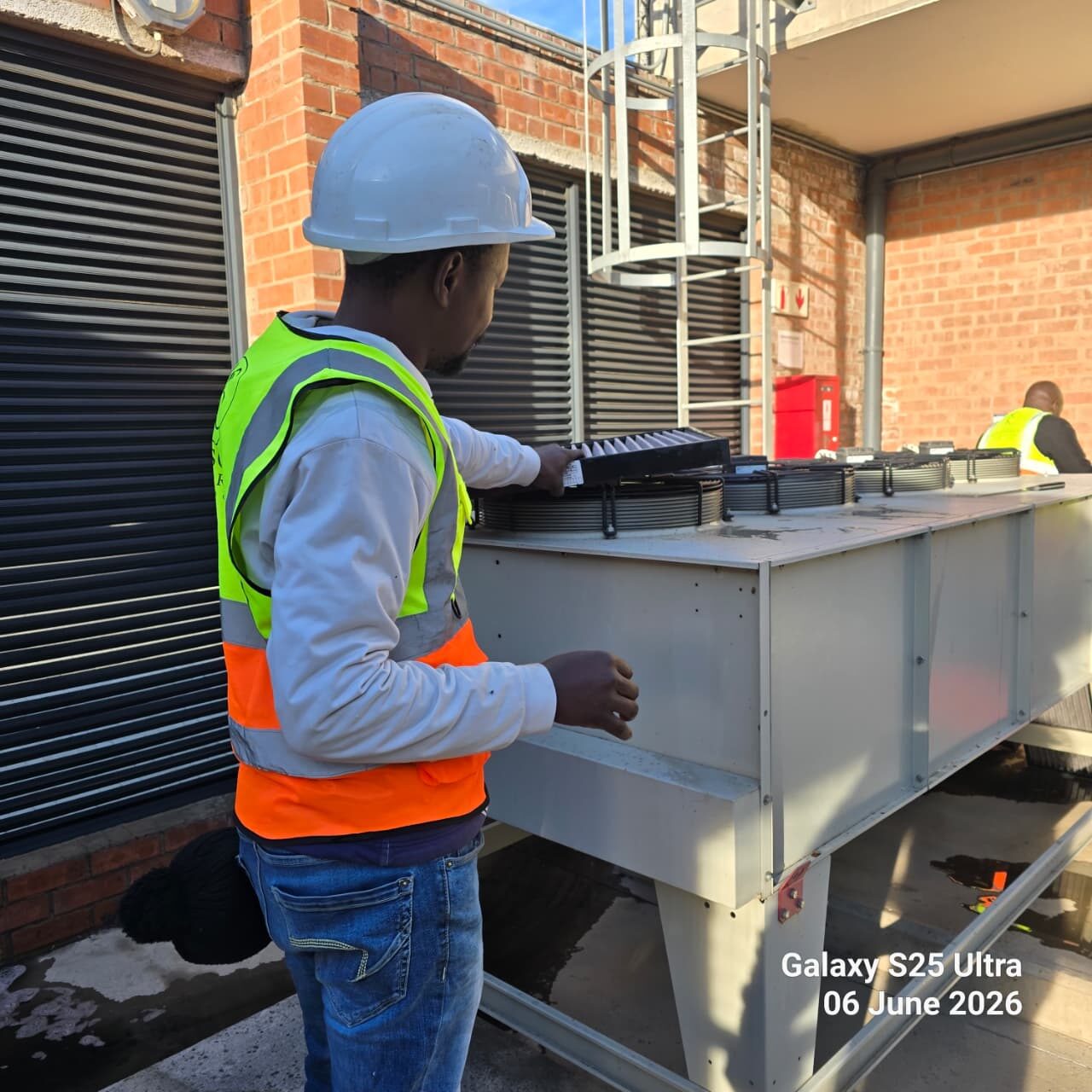 Technician working on an HVAC control panel