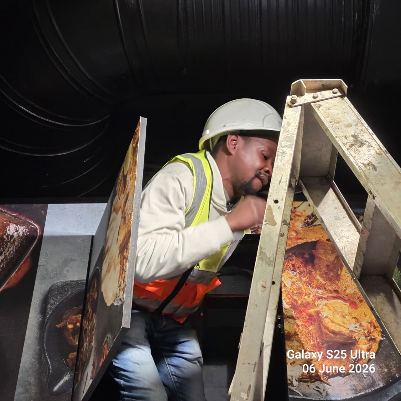 Technician inspecting equipment inside a dark plant room