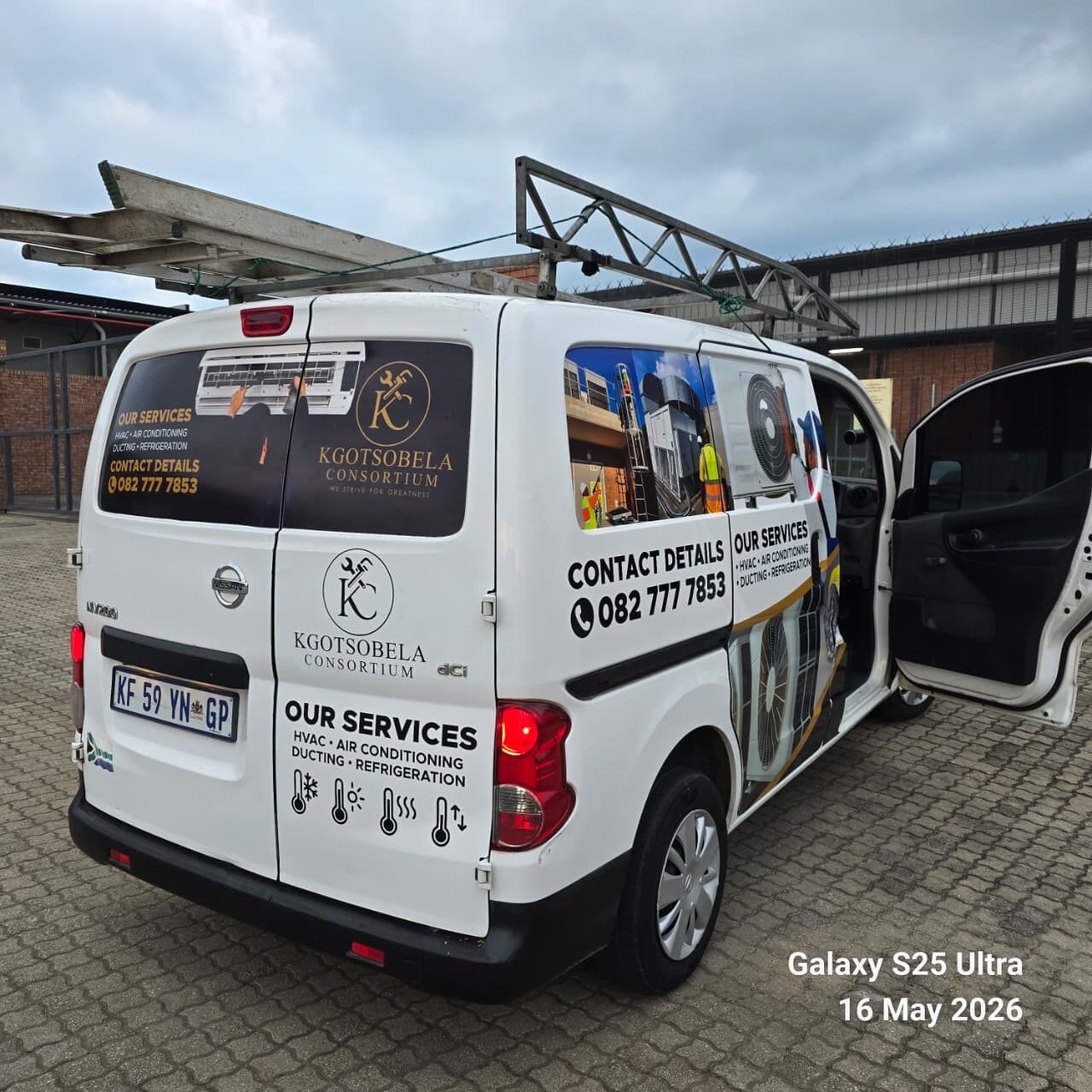 Rear view of a Kgotsobela Consortium branded service van with contact details