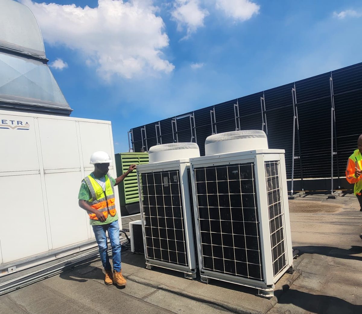 Kgotsobela Consortium technician with commercial air conditioning condenser units